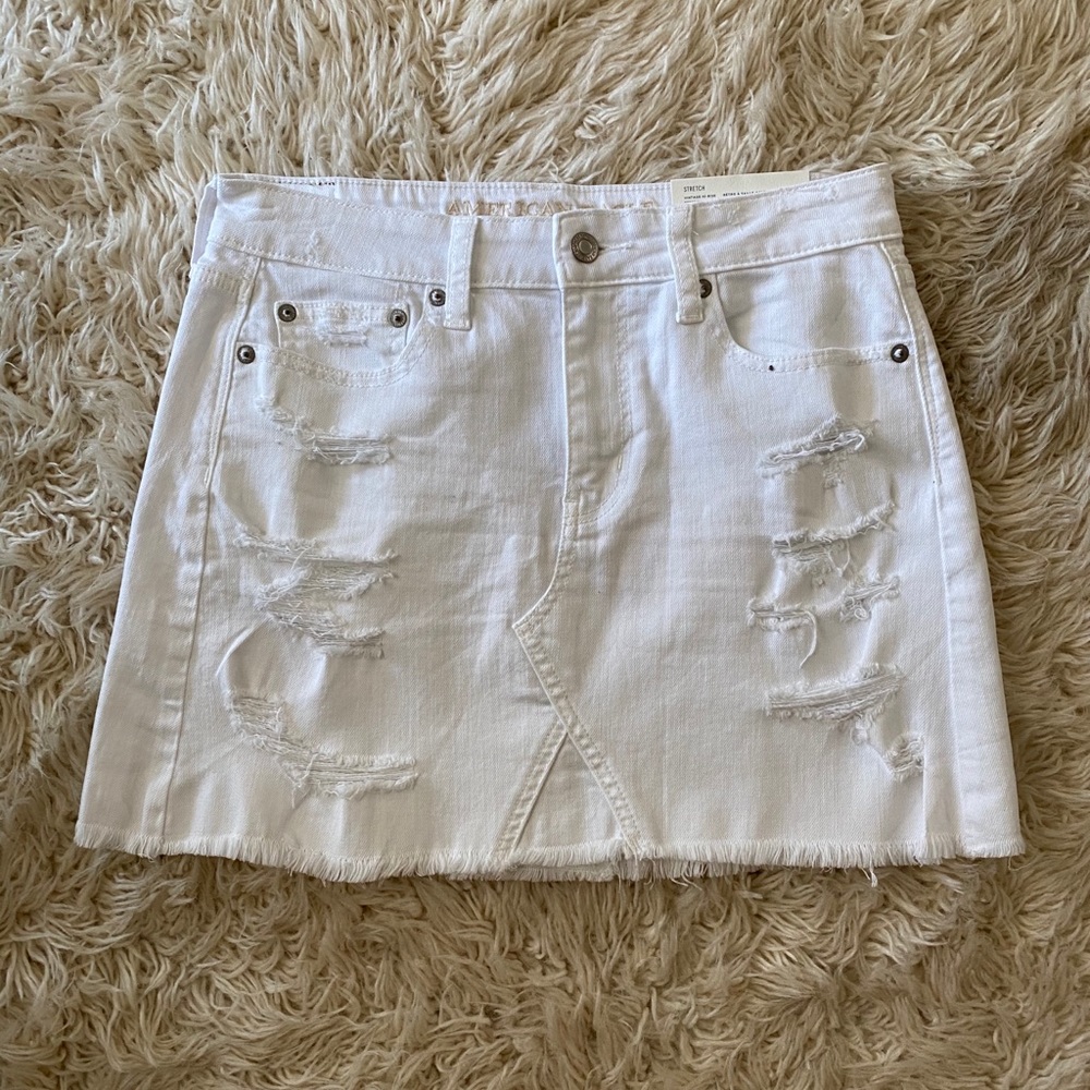 NWT High-Rise distressed denim mini skirt